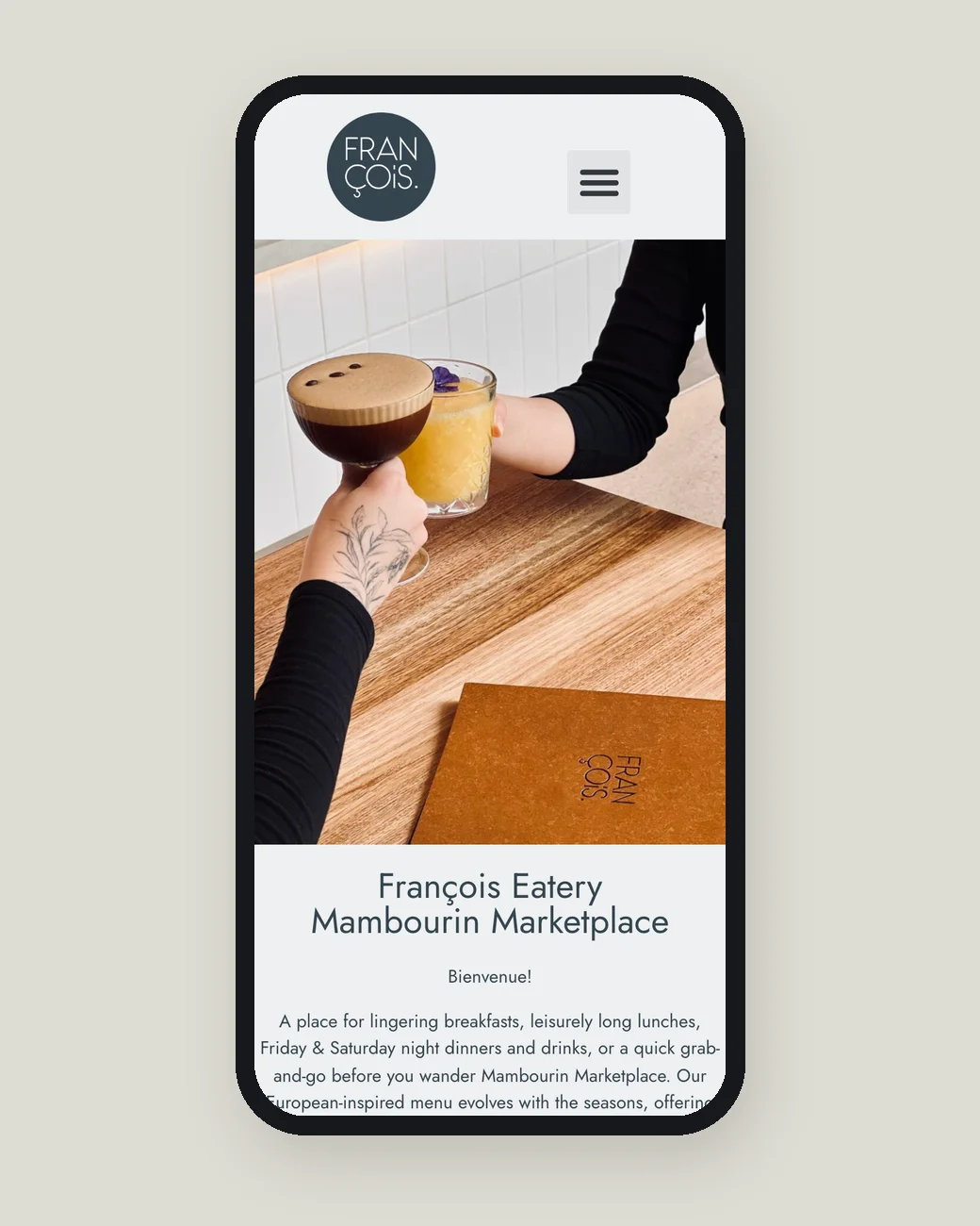 The cafe's current website on a phone